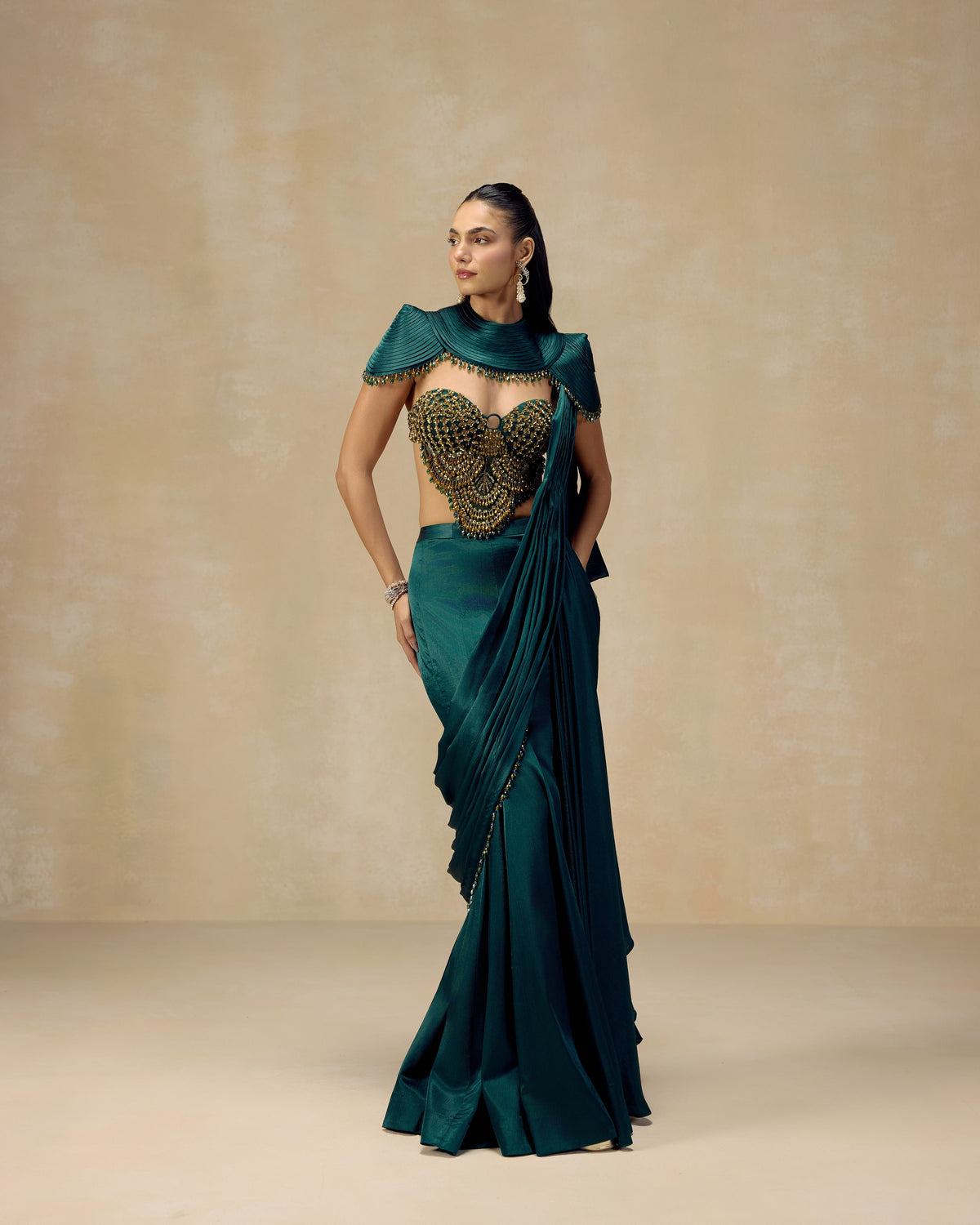 Teal green textured satin pre-draped saree with sequin corset blouse and pleated cape — RINESSA