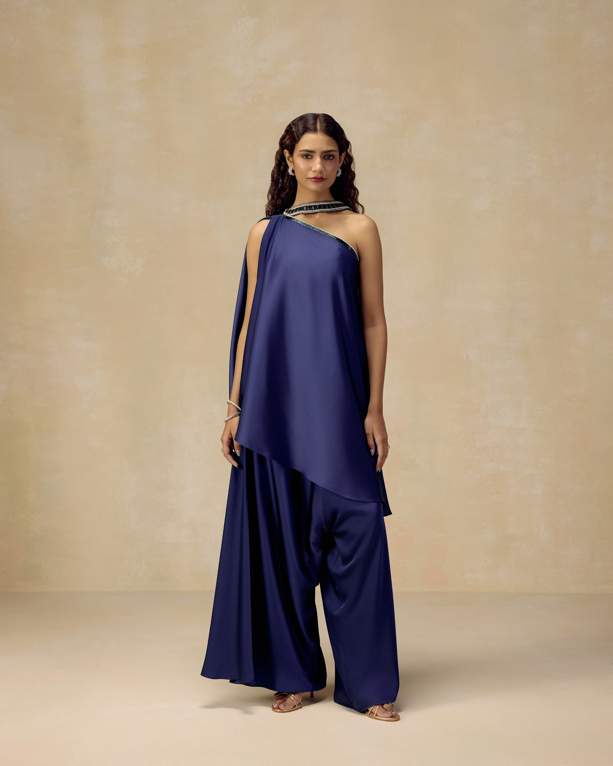 Navy blue one-shoulder silk satin tunic top with bustier, draped trousers and hand-embroidered stone neckline — RINESSA